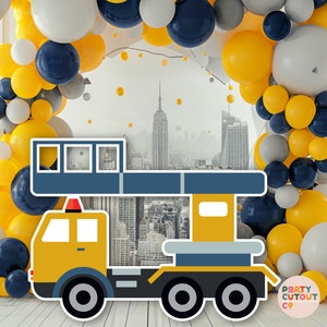 May include: A yellow construction crane cutout with a blue cab and a gray platform. The crane is in front of a backdrop of a city skyline with yellow, gray, and blue balloons.