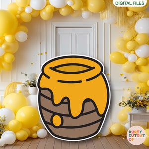 May include: A cartoon illustration of a honey pot with a brown exterior and a yellow honey filling. The honey is dripping down the sides of the pot. The pot is surrounded by yellow and white balloons.
