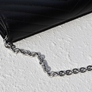 a black purse with a chain hanging from it