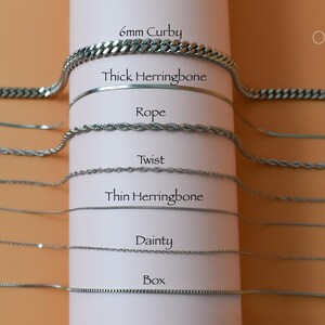 a variety of metal chain necklaces with different thicknesses and designs, arranged in a column on a white background.