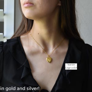 a woman wearing a black shirt and a gold necklace