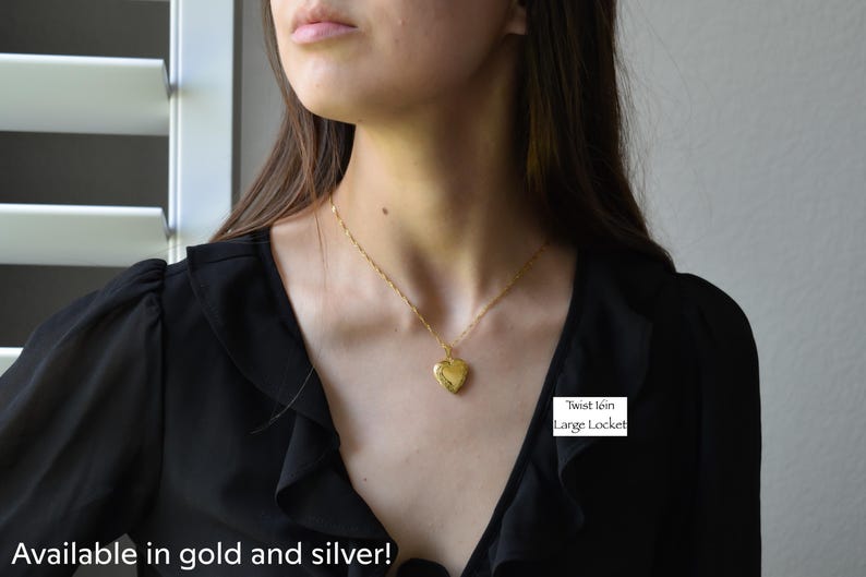a woman wearing a black shirt and a gold necklace