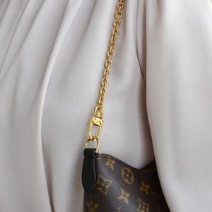 a close up of a person holding a purse