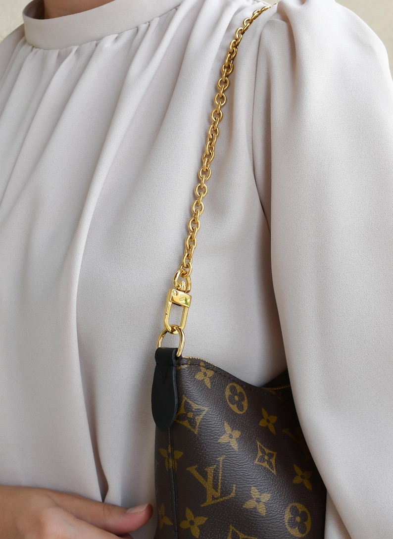 a close up of a person holding a purse