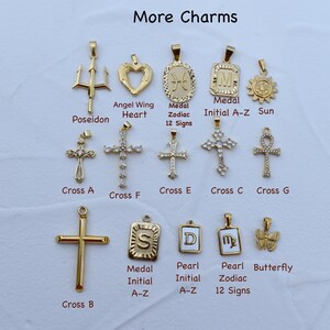 a bunch of different types of cross charms