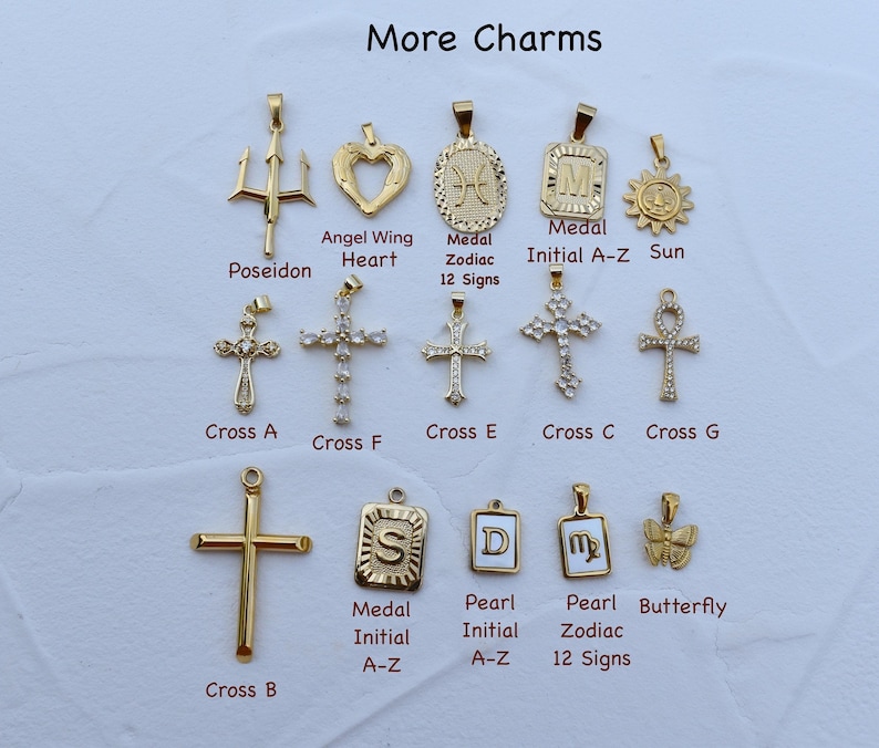 a bunch of different types of cross charms