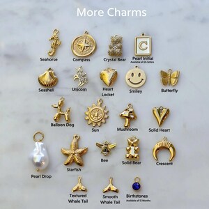 a white marble counter topped with lots of different types of charms