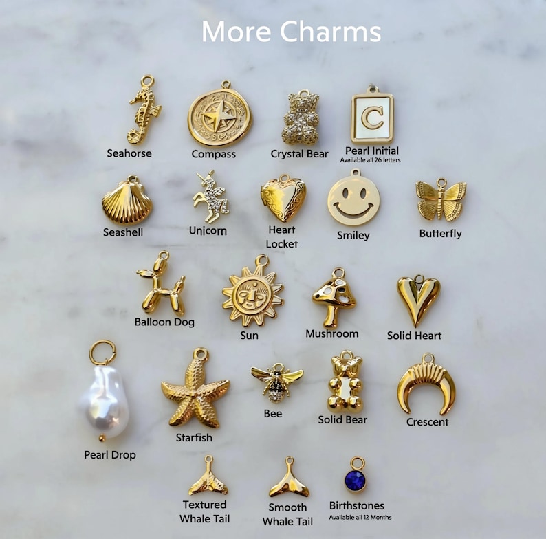 a white marble counter topped with lots of different types of charms