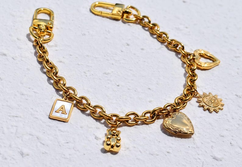 a gold bracelet with charms and charms on it