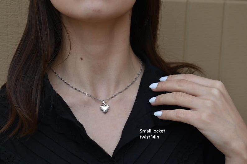 a woman wearing a necklace with a heart on it
