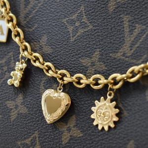 a close up of a bracelet with charms on it