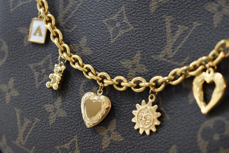 a close up of a bracelet with charms on it