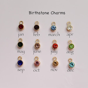 a group of different colored charms sitting on top of a table