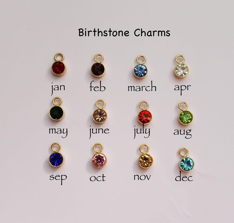 a group of different colored charms sitting on top of a table