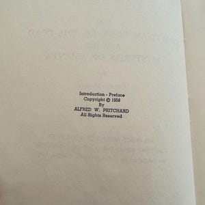 May include: An open book page with text from the book "Mysteries of the Dead". The text includes "Introduction - Preface", copyright information from 1958, and the author's name, Alfred W. Pritchard.
