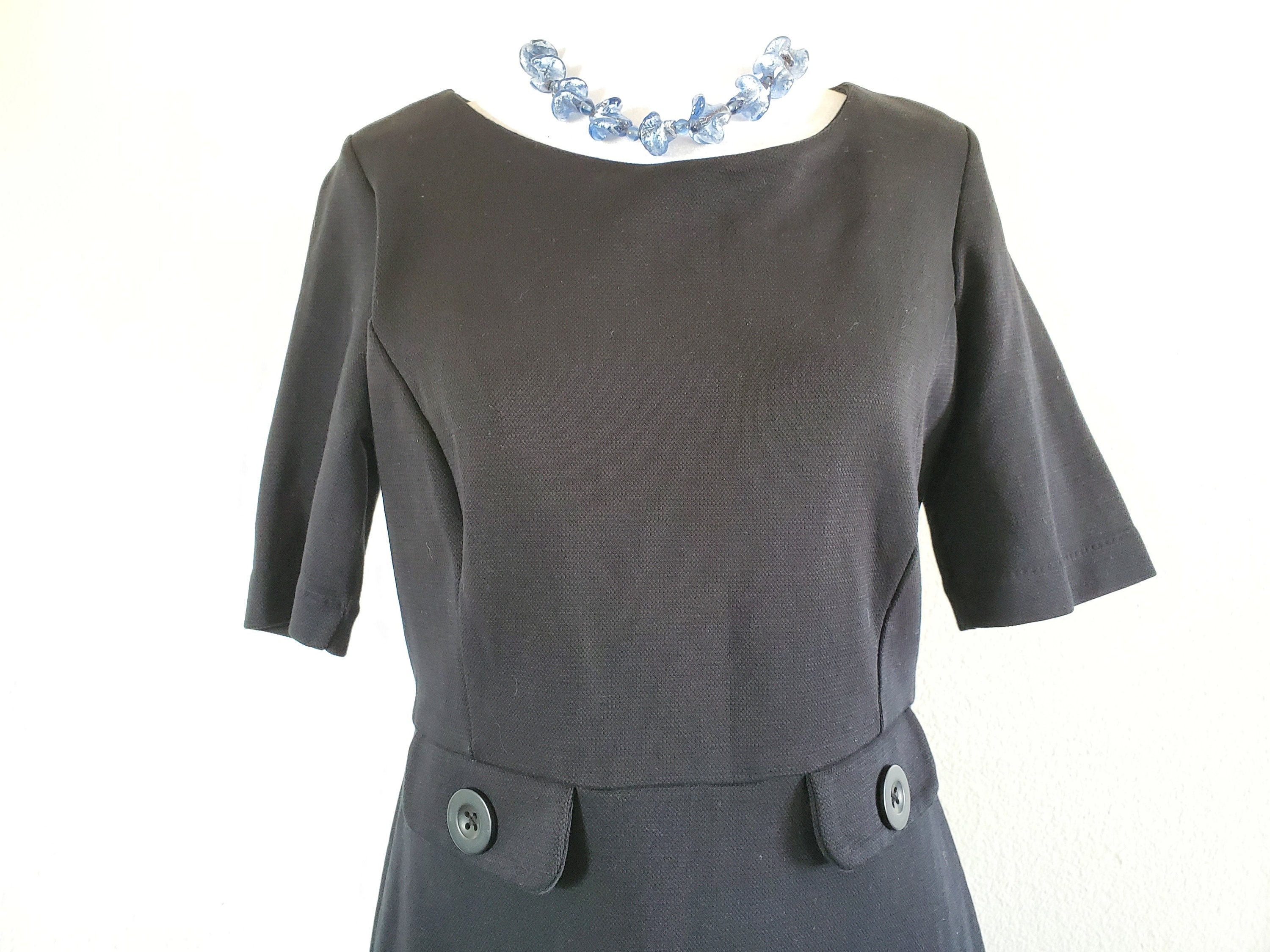 60s -70s Jewelry – Necklaces, Earrings, Rings, Bracelets Vintage 60S 70S Polyester Black Dress With Two Decorative Buttons On The Front  Short Sleeves, Scoop Neck $59.00 AT vintagedancer.com