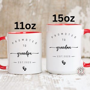 May include: Two white ceramic mugs with red rims. The 11 ounce mug says "Promoted to Grandpa Est. 2025" with a footprint symbol. The 15 ounce mug says "Promoted to Grandma Est. 2025" with a footprint symbol.
