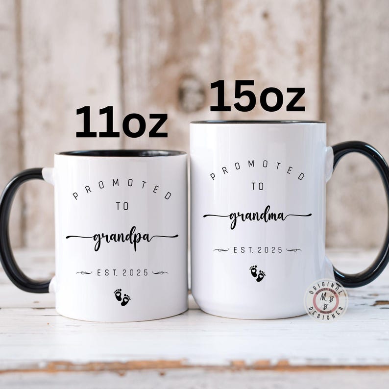 May include: Two white ceramic mugs with black handles and black rims. The 11oz mug says "Promoted to Grandpa Est. 2025" with a footprint symbol. The 15oz mug says "Promoted to Grandma Est. 2025" with a footprint symbol.