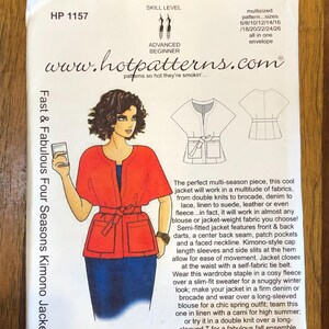 May include: A sewing pattern envelope for a Fast & Fabulous Four Seasons Kimono Jacket, model HP 1157. The white envelope features an illustration of a person wearing a red kimono-style jacket with a tie belt and patch pockets over a blue skirt.