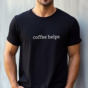 May include: A black t-shirt with the text "coffee helps" printed in white on the front.