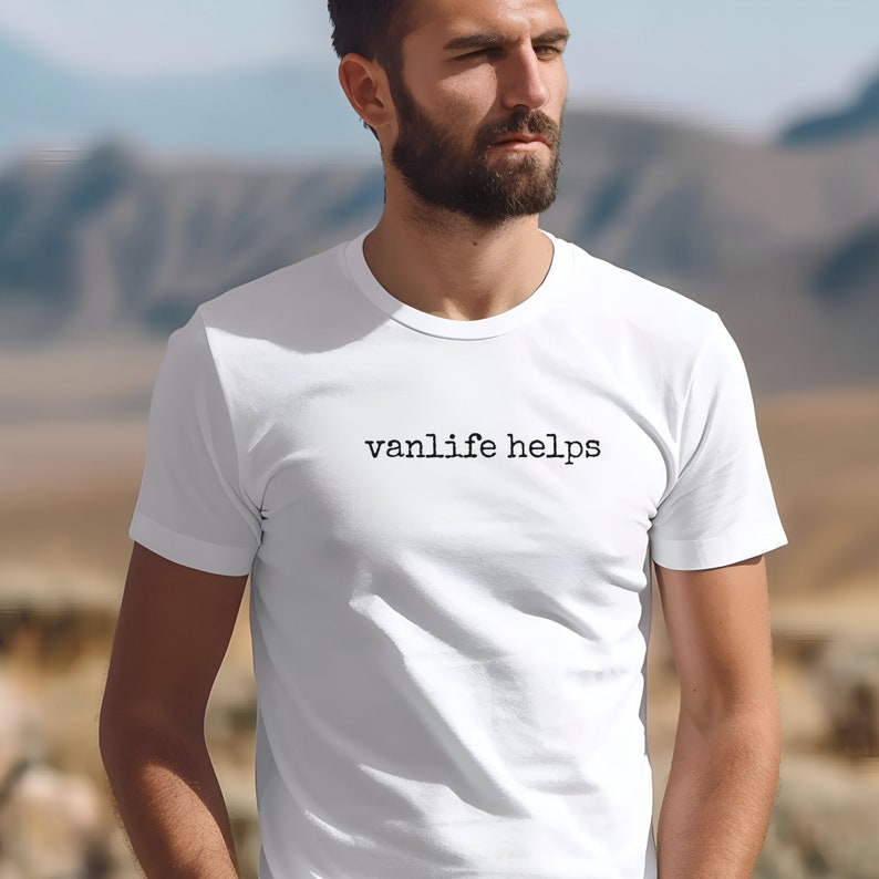 May include: White t-shirt with the text "vanlife helps" printed in black on the front.