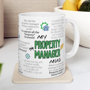 May include: White ceramic mug with a green and black design that says "My Property Manager Mug". The mug has text around the design that includes the phrases "To capture all the property moments!" and "What's a property manager's favorite ice cream flavor? Property peanut butter swirl!"