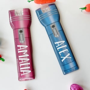 May include: A set of three ceramic mugs with a speckled, matte finish. The mugs are in shades of cream, light brown, and dark brown. Each mug has a simple, minimalist design and a rounded handle.