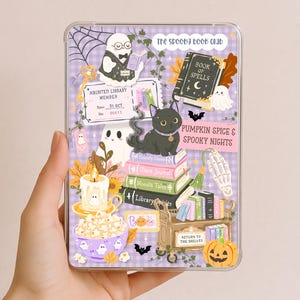 May include: A clear protective case for a tablet or e-reader featuring a purple gingham background with illustrations of a black cat, ghosts, a stack of books, a candle, a bowl of popcorn, a pumpkin, and text reading The Spooky Book Club.