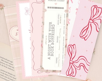 May include: A collection of pink and white bookmarks with bow and heart designs. One bookmark is a ticket that reads "A Night With Your Book Boyfriend" and "Romance Reader Ticket". The bookmarks are arranged on a light pink surface.