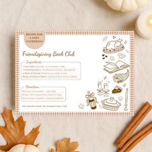 May include: A Friendsgiving Book Club invitation with a cozy theme. The invitation features a gingham border and illustrations of food and drink. The text includes the date, location, and RSVP information. Pumpkins, leaves, cinnamon sticks, and a candle are arranged around the invitation.