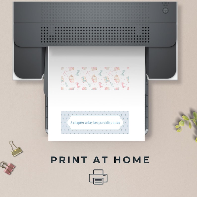 May include: A printer printing a white sheet of paper with a patterned design and the text "A chapter a day keeps reality away". The paper has a light blue border with white dots. The image also includes the text "PRINT AT HOME".