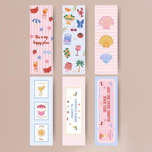 May include: Six rectangular bookmarks featuring various illustrations. Designs include pink stripes with the text 'this is my happy place', a blue dotted pattern with food and nature icons, pink wavy lines with seashells, and blue striped panels with text.