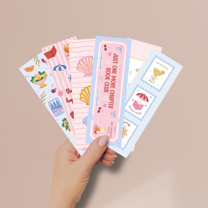 May include: A set of five rectangular paper bookmarks featuring colorful illustrations of seashells, citrus fruits, beach umbrellas, and books. One bookmark is designed like a ticket with the text Just One More Chapter Book Club.
