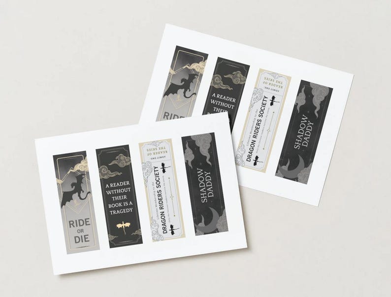 May include: Four printable bookmarks with a black and white dragon design. The bookmarks feature the text "Ride or Die", "A reader without their book is a tragedy", "Dragon Riders Society", and "Shadow Daddy".