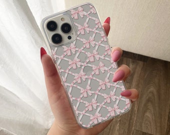 May include: A clear phone case with a pink and white bow pattern. The case is designed for an iPhone.