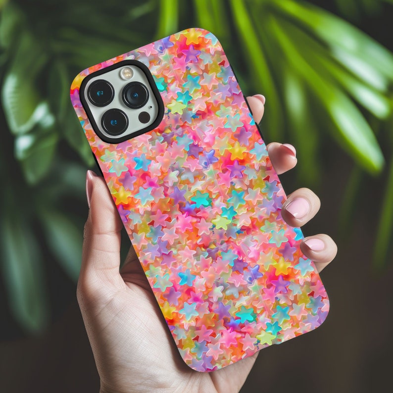 May include: A phone case with a colorful pattern of stars. The stars are in shades of pink, blue, yellow, and orange.