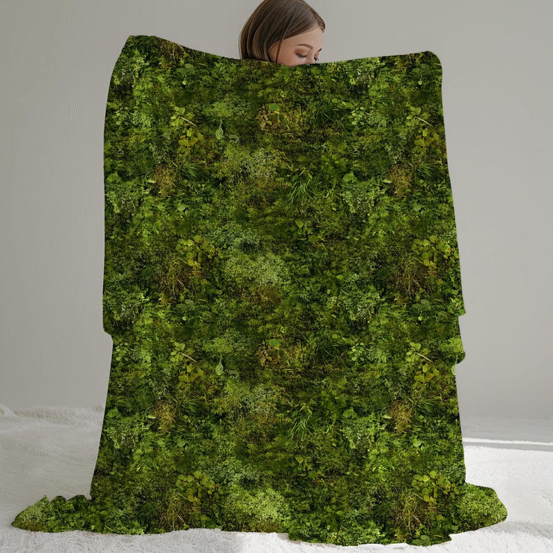 May include: A green and brown throw blanket with a mossy pattern. The blanket is made of soft, plush fabric and is perfect for cuddling up on the couch.