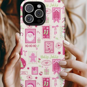 May include: A phone case with a festive Christmas design. The case features a cream background with pink and green postage stamp-style illustrations of Santa Claus, gingerbread men, stockings, and gifts. The words "HO HO HO" and "Holly Jolly" are visible.