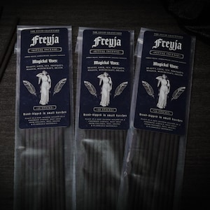May include: Three packages of Freyja Ritual Incense. Each package has a dark blue label with white text and a drawing of a woman. The text includes "Magichal Uses: Beauty, Love, Sex, Fertility, Magick, Witchcraft, Death."
