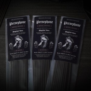May include: Three packets of Persephone ritual incense. Each packet features a black label with white text and an illustration of a woman. The text includes "Magichal Uses: Renewal, Growth, Balance, Underworld Connection" and "10 Sticks".