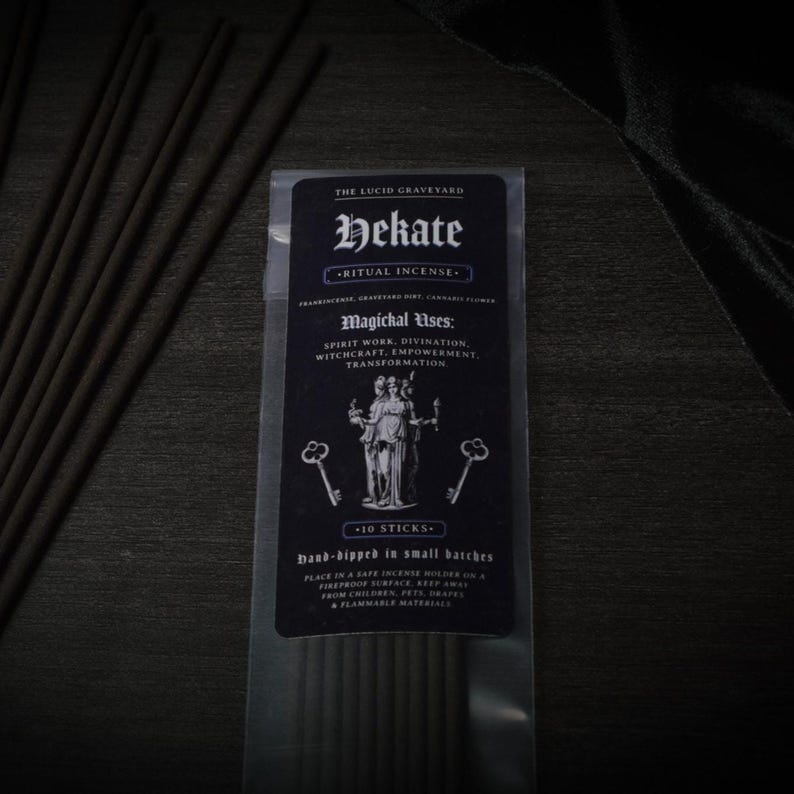May include: A package of Hekate ritual incense sticks from The Lucid Graveyard. The black label features the name "Hekate", the words "Ritual Incense", and a graphic of two figures. The package contains 10 hand-dipped sticks.
