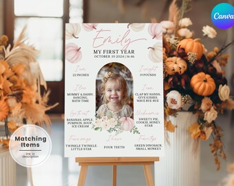 May include: A personalized first-year milestone sign featuring a photo of a smiling toddler. The sign includes the child's name, date, height (22 inches), weight (19 pounds), and favorite things, with a pumpkin and floral design.