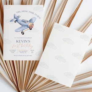 May include: A blue and white airplane with clouds in the background. The text on the invitation reads "Oh, how time flies!" It's on over to celebrate Kevin's first birthday. Saturday, August 19th, from 2-4 PM. 123 Air Drive, Yuma, TX. RSVP to Emily at 123-456-7890.