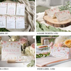 A laptop screen displaying an editable Canva baby shower invitation template surrounded by printed cards and envelopes, all featuring watercolor pink cosmos wildflowers and green foliage on a soft ivory background in a botanical style.