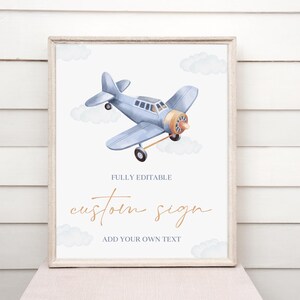 May include: A printable sign with a watercolor illustration of a blue airplane flying in the sky with clouds. The sign says "Fully Editable Custom Sign Add Your Own Text".