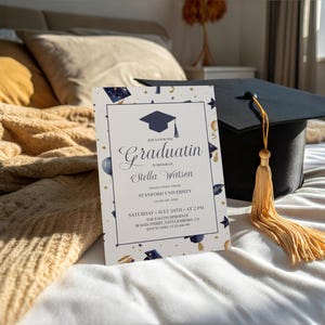 May include: A graduation invitation with a blue and gold color scheme. The invitation features a graduation cap, stars, and balloons. The text on the invitation reads "Graduatin" and "Stella Watson". The invitation also includes the date and time of the graduation ceremony.