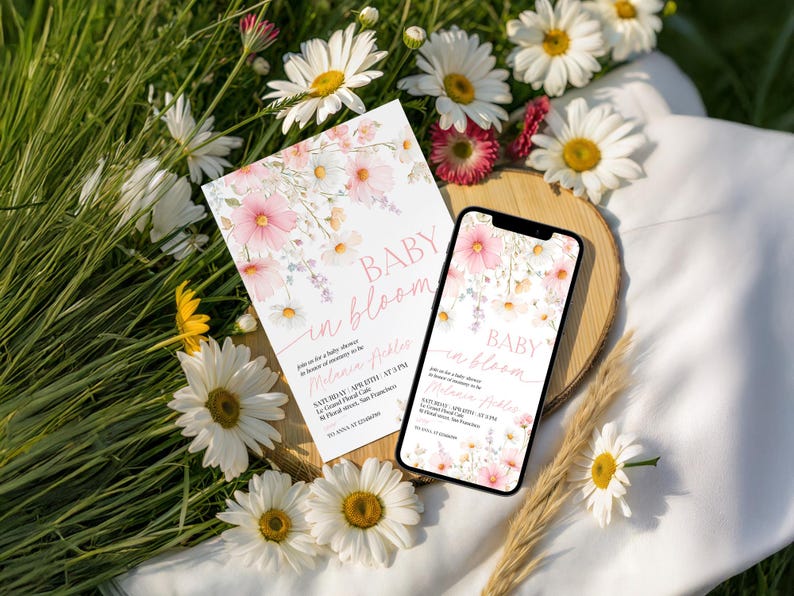 A baby shower stationery bundle showcasing watercolor pink cosmos and wildflower accents on a soft cream backdrop, with coordinating invitation, RSVP card, signage, and banner, featuring delicate script typography and botanical illustration style, fully editable in Canva.