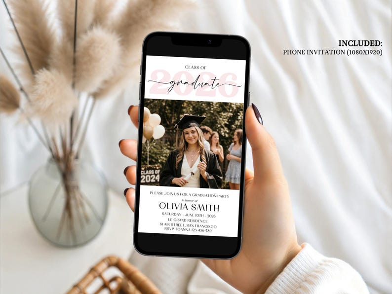 Modern digital graduation invitation showing a rectangular photo frame atop a soft pink watercolor brushstroke background, bold black serif lettering reading Class of 2026, minimalist sans-serif text below for name and event details, designed as a mobile-friendly evite or printable announcement.