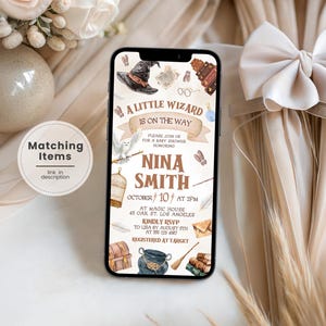 May include: A smartphone displaying a digital baby shower invitation with the text A LITTLE WIZARD IS ON THE WAY, NINA SMITH, OCTOBER 10 AT 2PM, AT MAGIC HOUSE 45 OAK ST. LOS ANGELES, KINDLY RSVP TO LISA BY AUGUST 5TH AT 555 123 4567, REGISTERED AT TARGET.