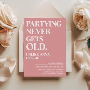 May include: Pink invitation card with white text that reads "Partying Never Gets Old. Unlike Anna. He's 40."  The invitation is for a party on Saturday, December 11th, from 7pm until late at 51 Floral Street, San Francisco. RSVP to Anna at 123456789. Dinner and drinks are provided.